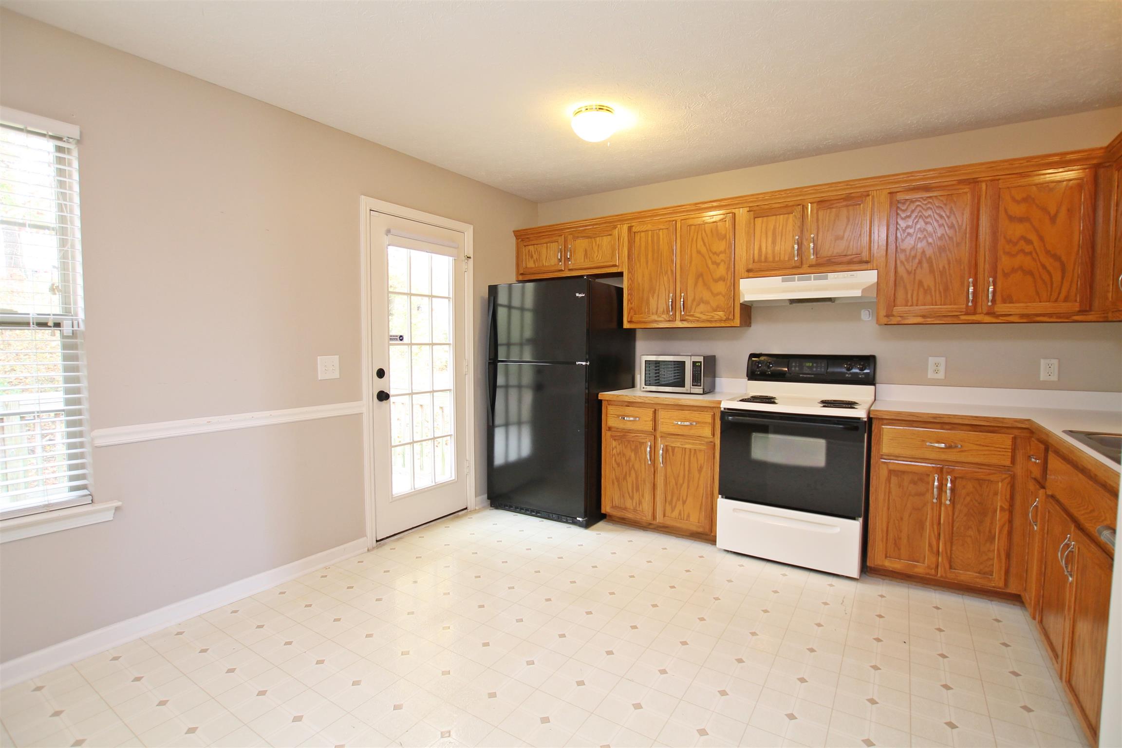 808 Hunters Crossing Lane Springfield, TN 37172 - Photo 10 of 30 a kitchen with granite countertop a refrigerator stove top oven and sink