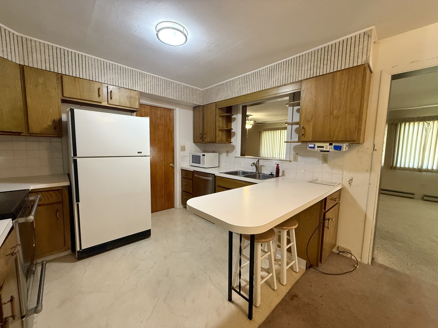 1340 Jeffrey Drive Rantoul, IL 61866 - Photo 4 of 18 a kitchen with a refrigerator a stove top oven a sink and dishwasher