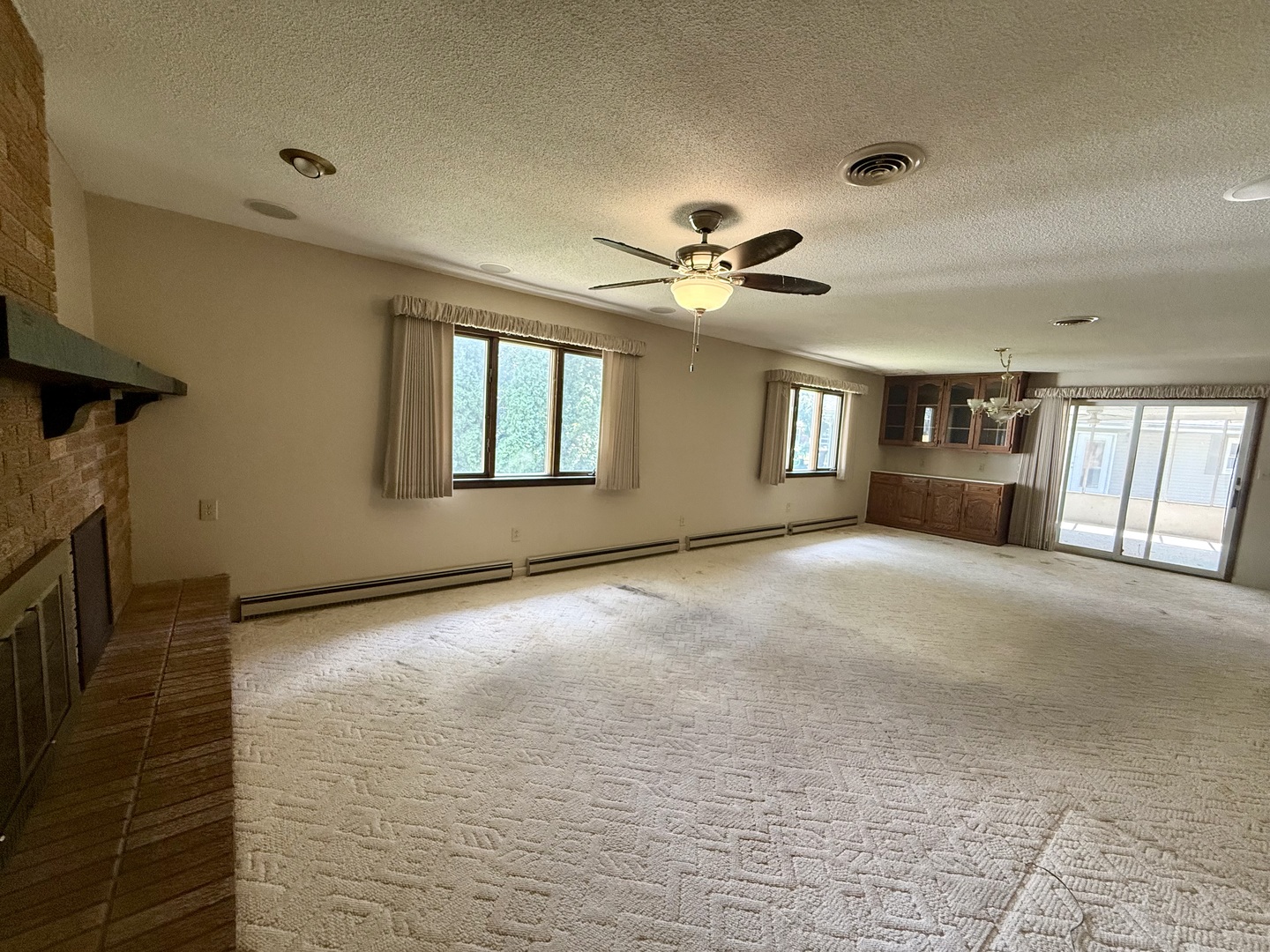 1340 Jeffrey Drive Rantoul, IL 61866 - Photo 9 of 18 a view of an empty room with a fireplace and a window