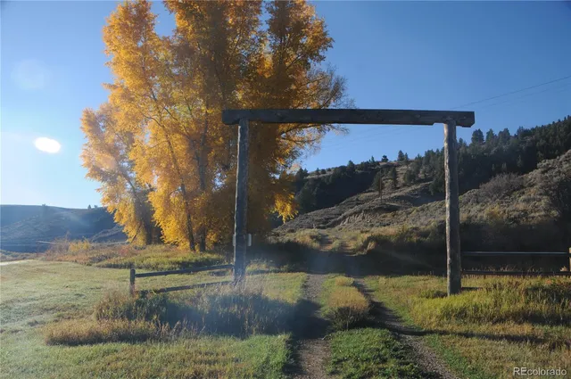 a living room with furniture and a mirror