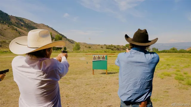 a view of a patio with table and chairs