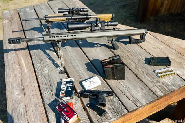 a kitchen with a table chairs sink and wooden floor