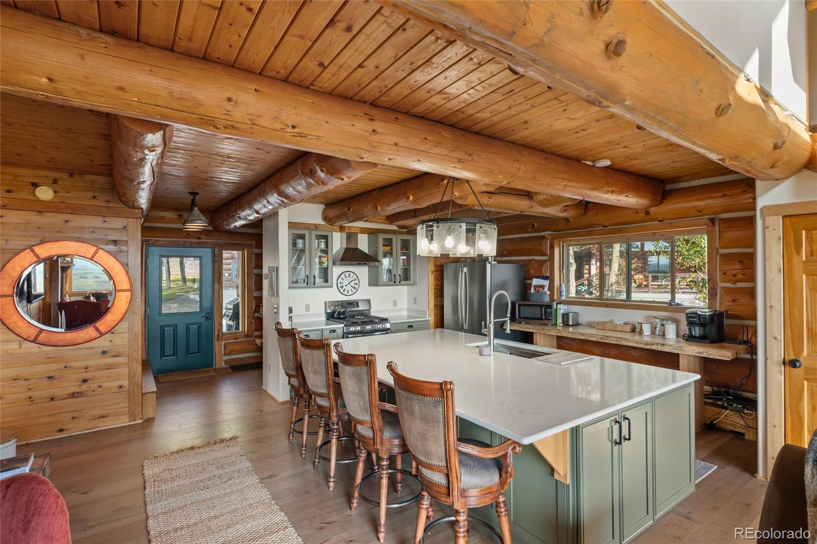 1853 County Road Kremmling, CO 80459 - Photo 25 of 50 a kitchen with a table chairs sink and wooden floor