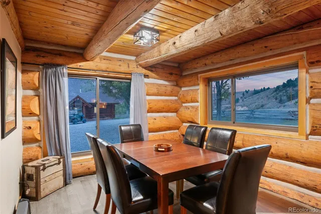 a view of a patio with couches and table and chairs with wooden floor