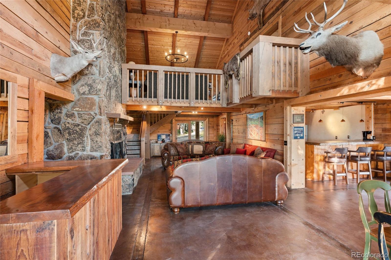 1853 County Road Kremmling, CO 80459 - Photo 41 of 50 a view of a patio with couches and table and chairs with wooden floor