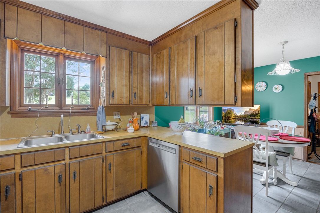 131 Bowen Road Anderson, SC 29621 - Photo 13 of 36 Rich wood cabinetry and a double sink frame this classic kitchen with dining area views.