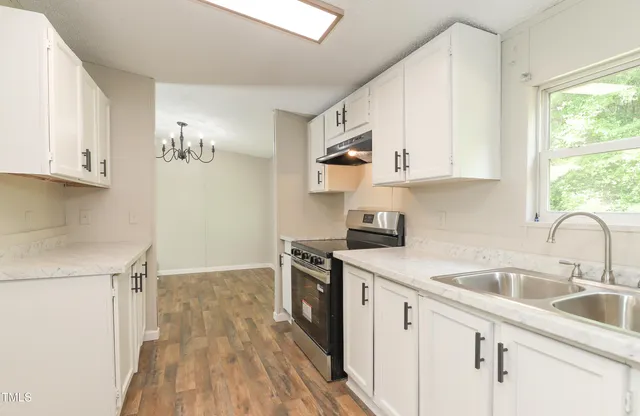 a kitchen with cabinets a sink and appliances