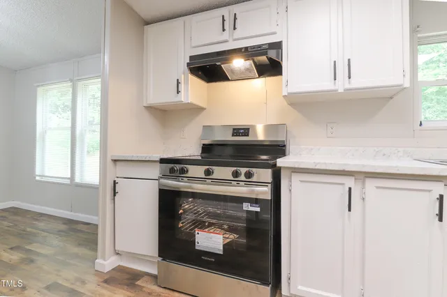a kitchen with a stove and a microwave