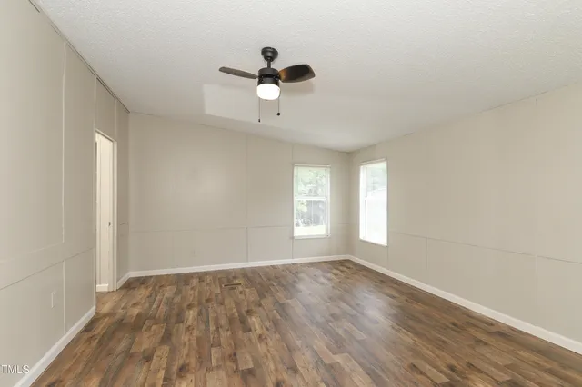 wooden floor in an empty room with a window