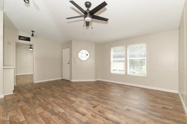 wooden floor in an empty room with a window