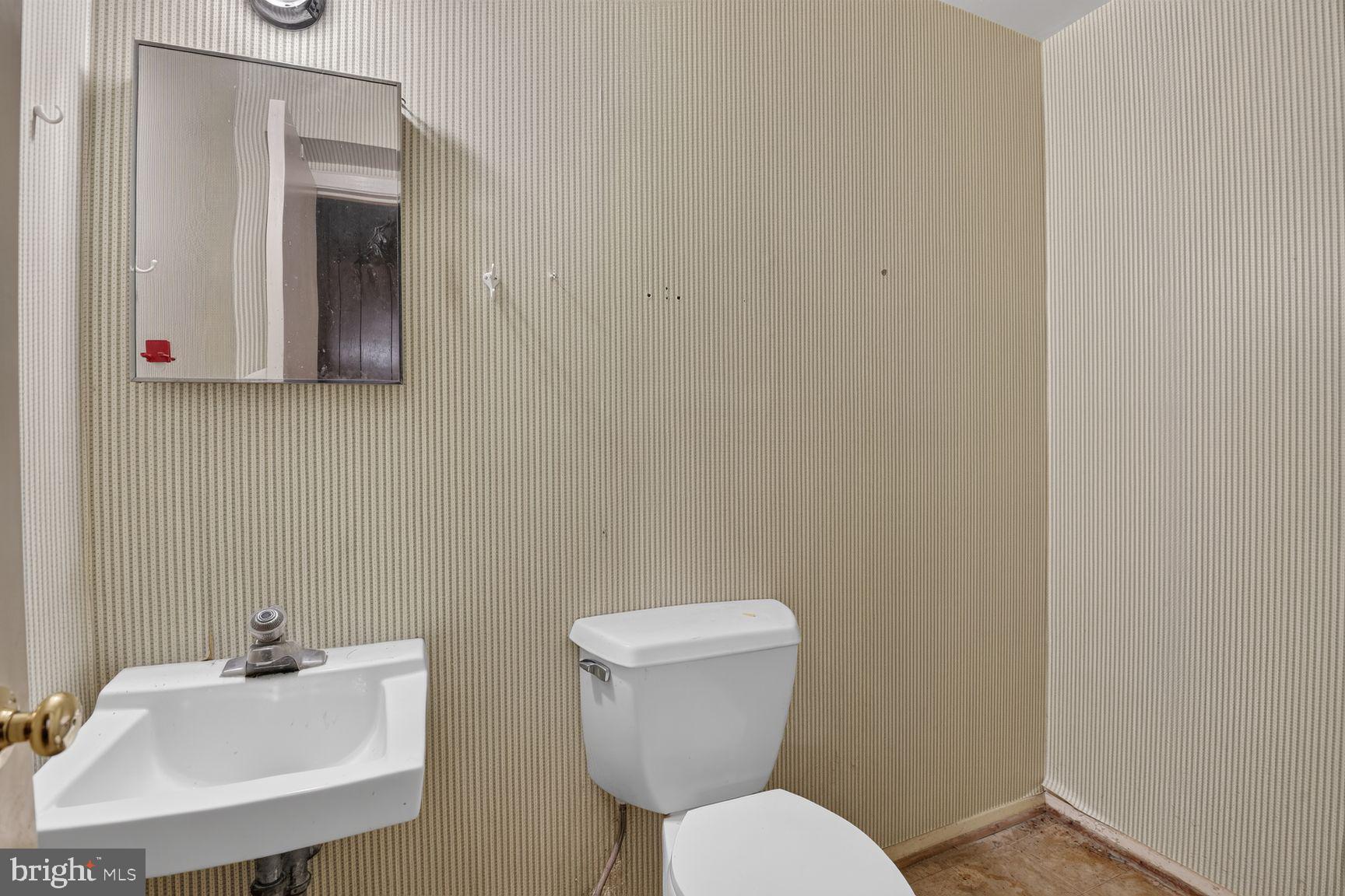 1326 Gresham Road Silver Spring, MD 20904 - Photo 21 of 30 a bathroom with a toilet sink and mirror