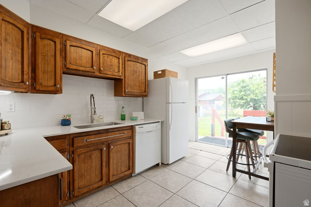 673 East 700 South Springville, UT 84663 - Photo 11 of 43 Kitchen featuring wood cabinetry, white subway tile backsplash, white countertops, and tile flooring