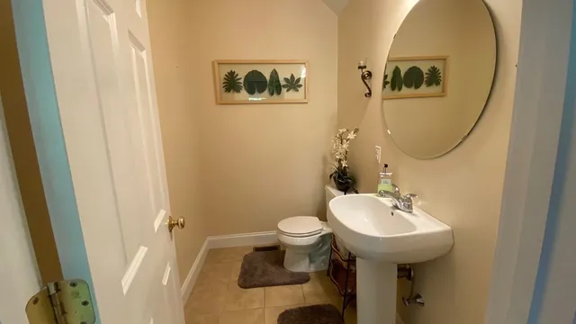 a living room with furniture a rug a lamp and a rug