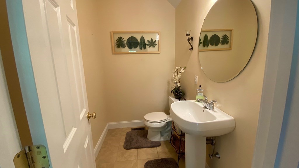 73 Zain Circle, Unit 73 Milford, MA 01757 - Photo 11 of 16 a bathroom with a toilet sink and mirror