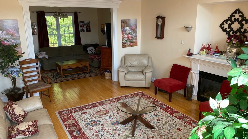 73 Zain Circle, Unit 73 Milford, MA 01757 - Photo 12 of 16 a living room with furniture a rug a lamp and a rug