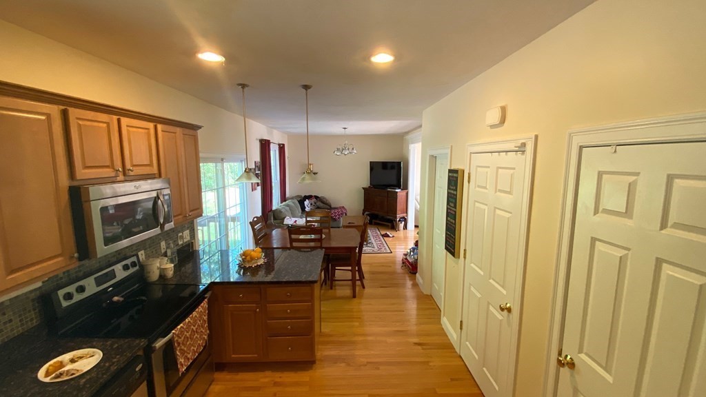 73 Zain Circle, Unit 73 Milford, MA 01757 - Photo 13 of 16 a view of a hallway with couch and wooden floor