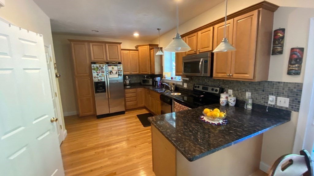 73 Zain Circle, Unit 73 Milford, MA 01757 - Photo 15 of 16 a kitchen with a sink stove and refrigerator