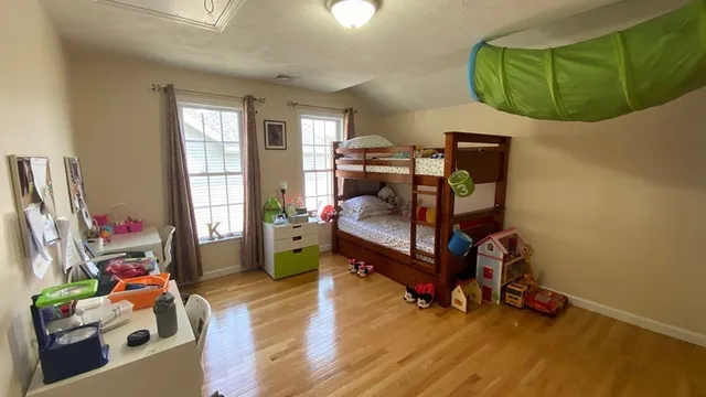 a bedroom with furniture and a wooden floor