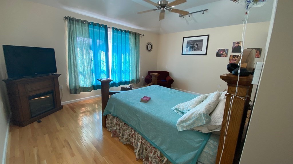 73 Zain Circle, Unit 73 Milford, MA 01757 - Photo 9 of 16 a bedroom with a bed and a flat screen tv