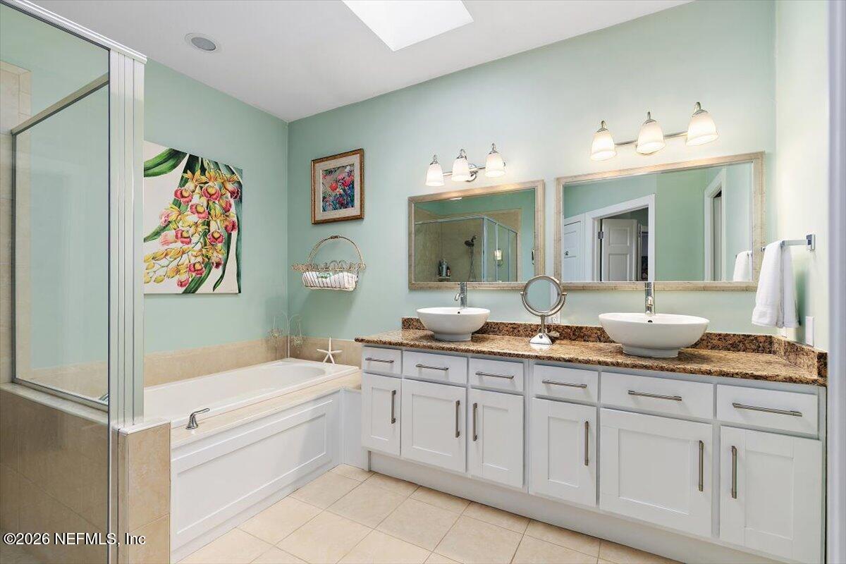 189 Laurel Lane Ponte Vedra Beach, FL 32082 - Photo 11 of 31 a spacious bathroom with a granite countertop sink mirror and bathtub