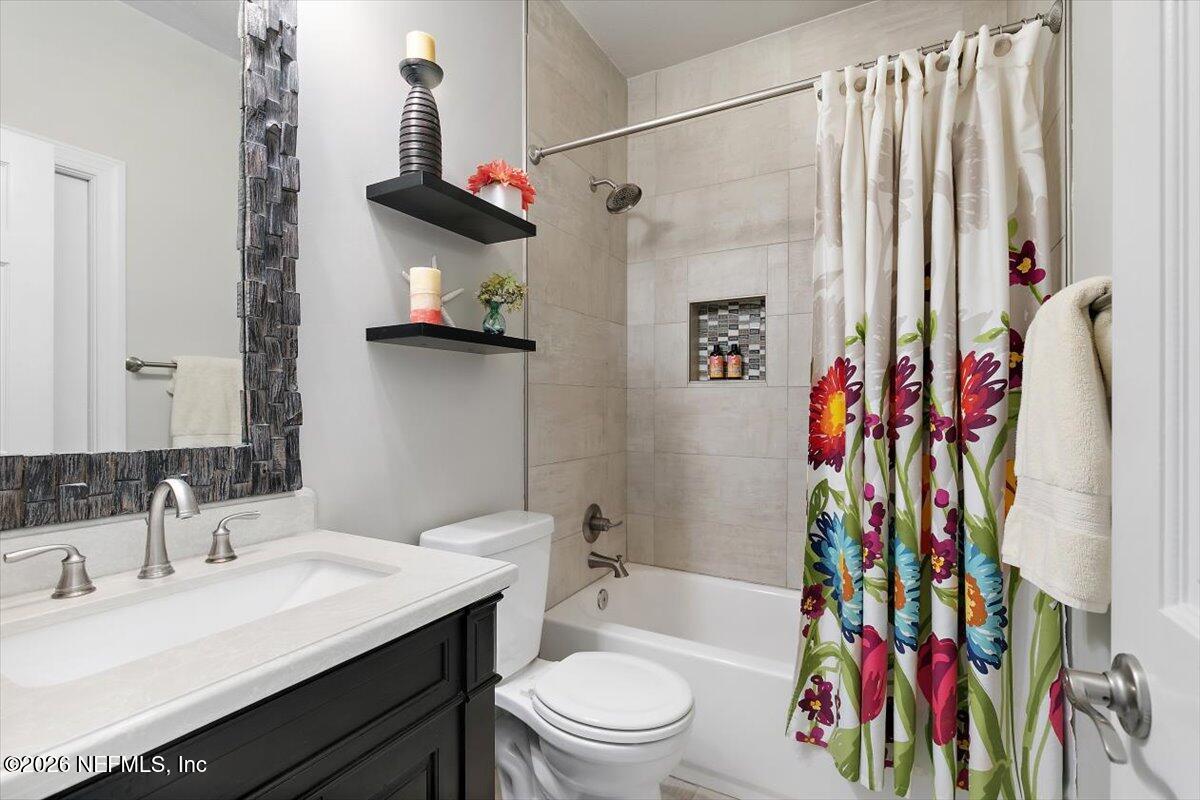 189 Laurel Lane Ponte Vedra Beach, FL 32082 - Photo 13 of 31 a bathroom with a sink a toilet and shower curtain