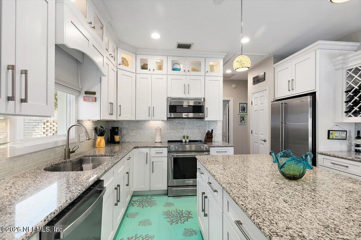 189 Laurel Lane Ponte Vedra Beach, FL 32082 - Photo 21 of 31 a kitchen with stainless steel appliances granite countertop a sink stove and refrigerator