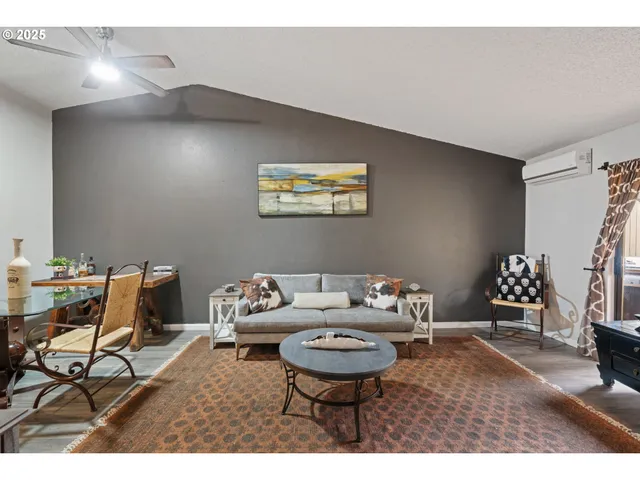 a living room with furniture and a chair