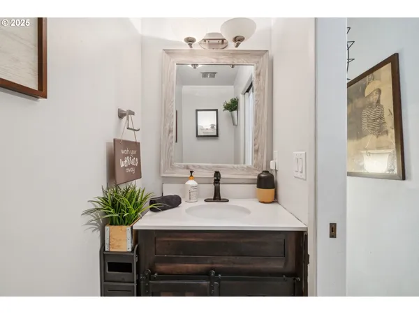 a bathroom with a sink vanity and a mirror