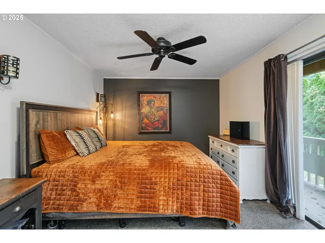 a bedroom with a large bed and a window