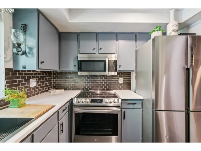 a kitchen with a sink stove and refrigerator