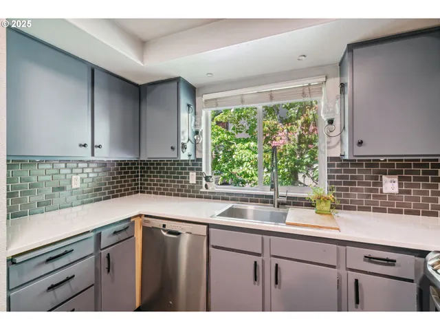 a kitchen with a sink and large window