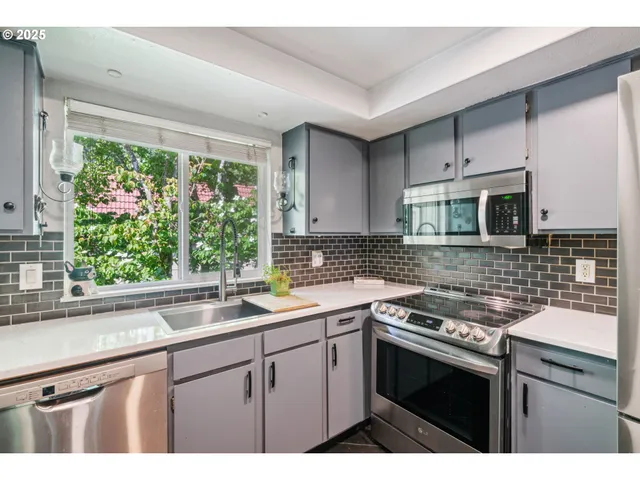 a kitchen with a sink stove and microwave