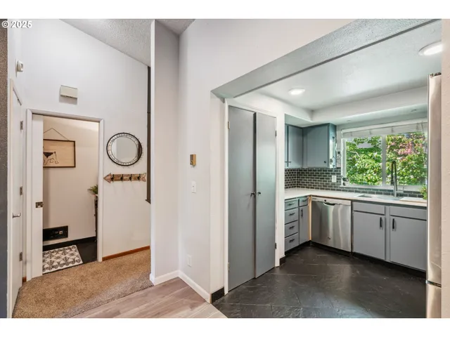 a open kitchen with refrigerator and window