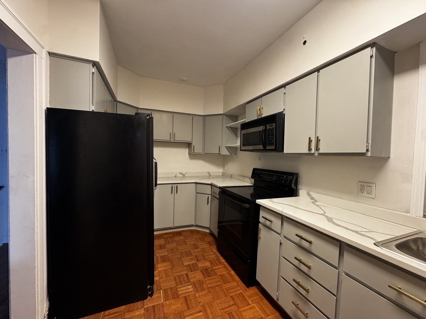 6937 South Merrill Avenue, Unit 1 Chicago, IL 60649 - Photo 13 of 17 a kitchen with a refrigerator stove and sink