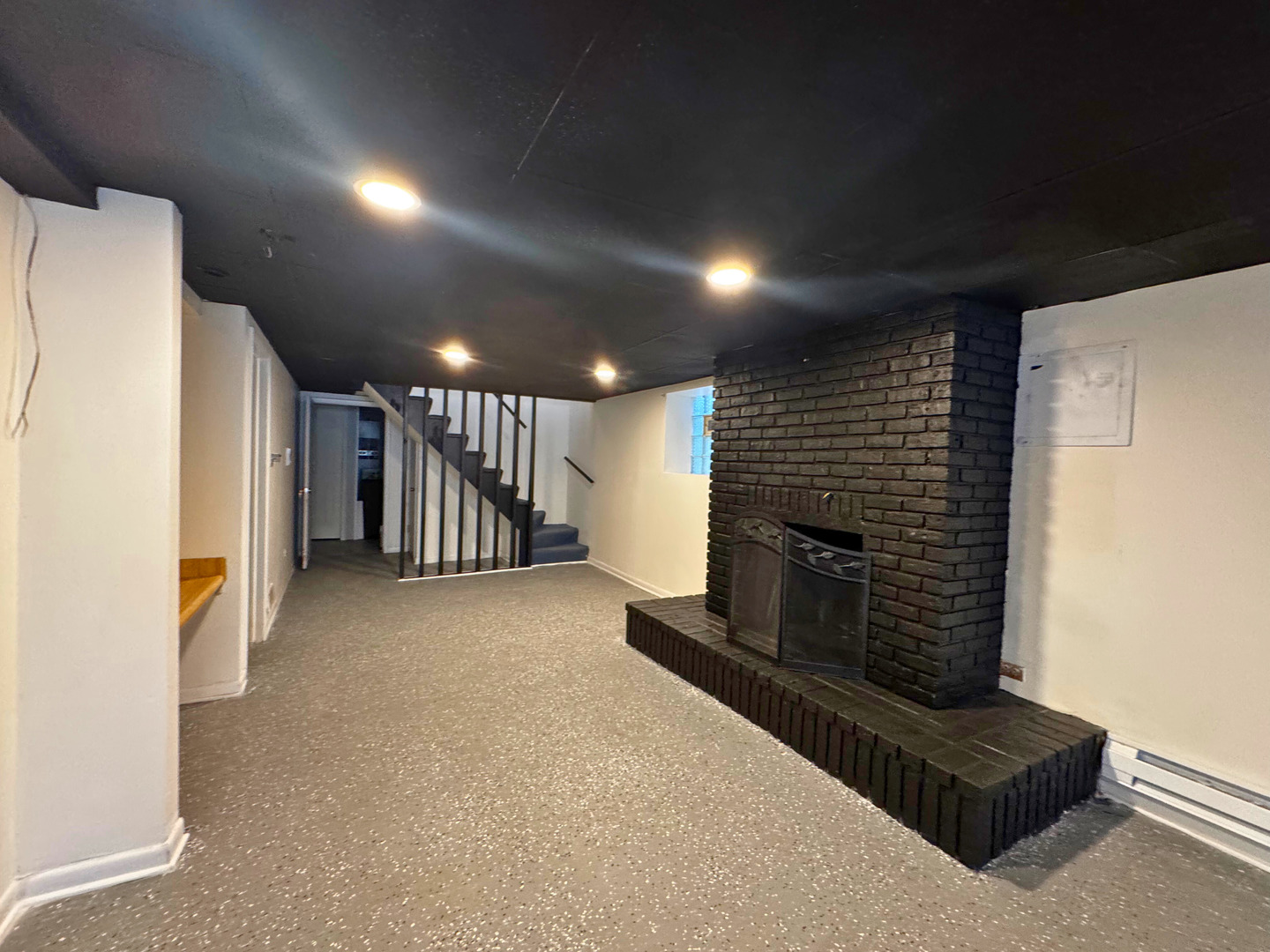 6937 South Merrill Avenue, Unit 1 Chicago, IL 60649 - Photo 17 of 17 a view of hallway with a couch and a fireplace