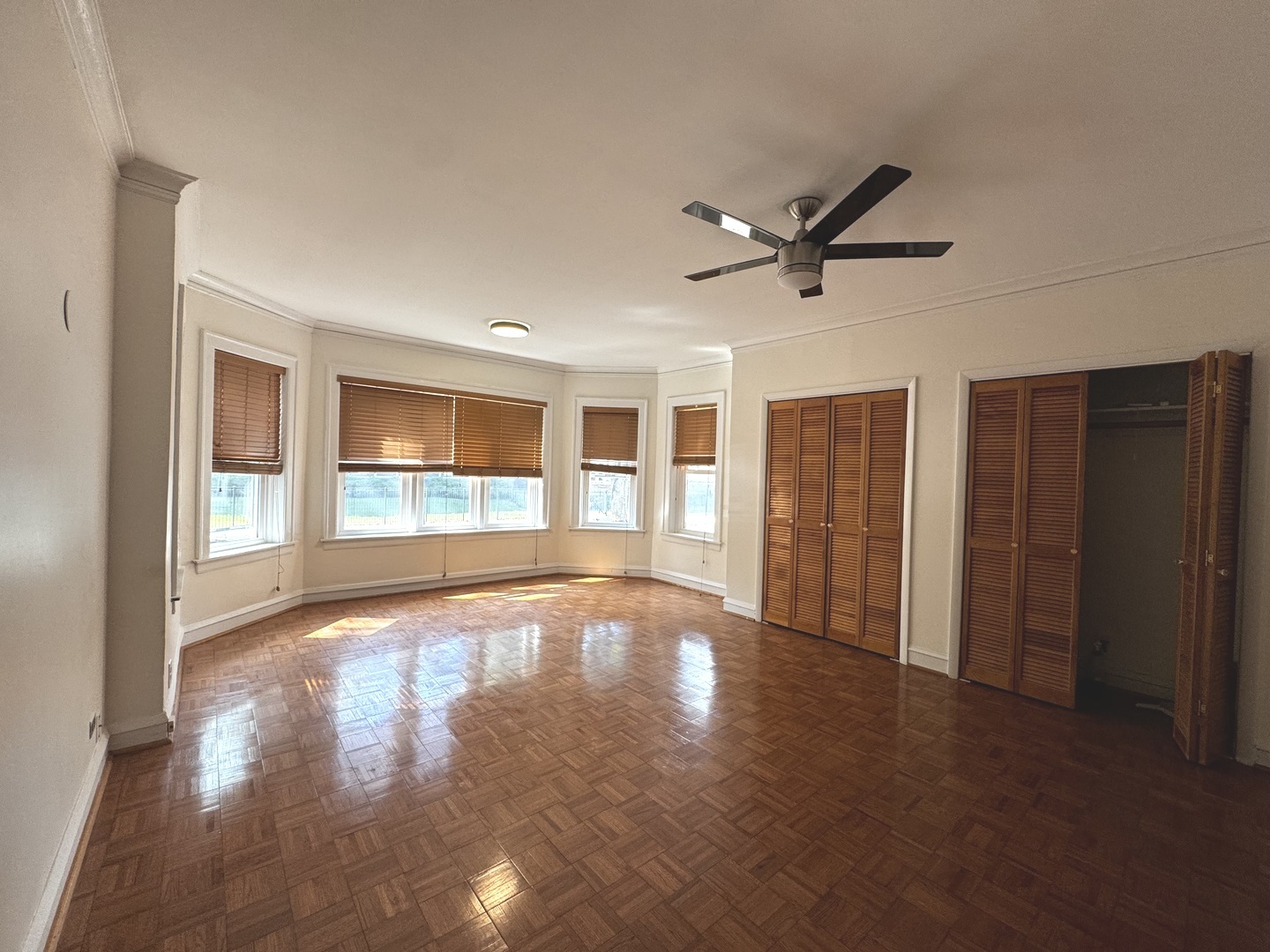 6937 South Merrill Avenue, Unit 1 Chicago, IL 60649 - Photo 2 of 17 a view of an empty room with a window and wooden floor