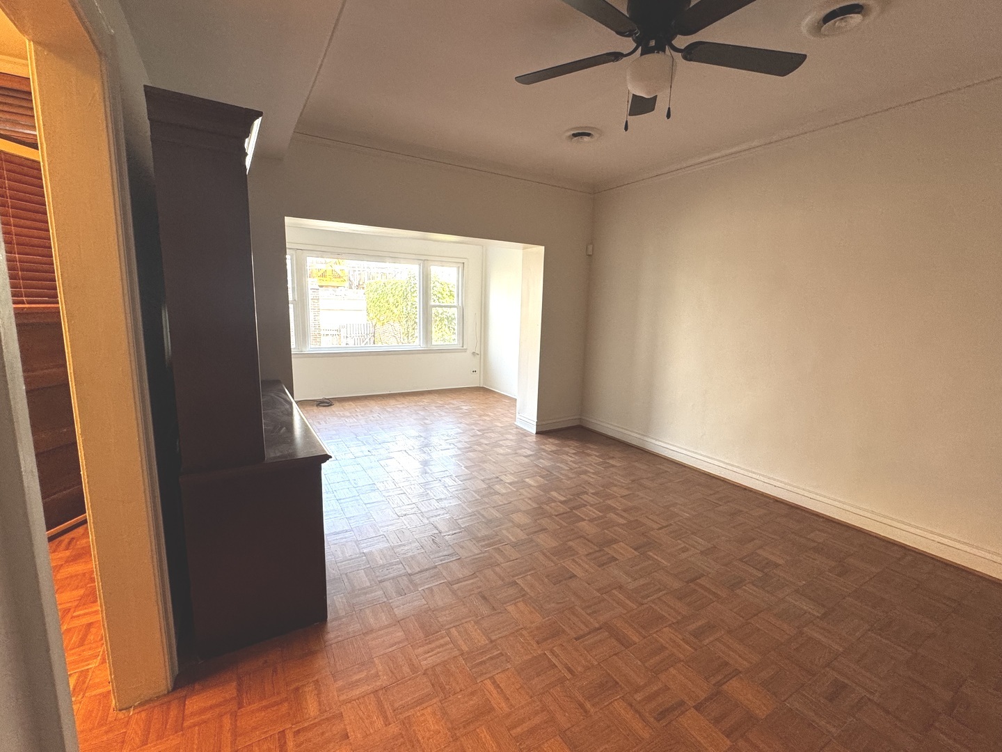 6937 South Merrill Avenue, Unit 1 Chicago, IL 60649 - Photo 4 of 17 a view of an empty room with a window
