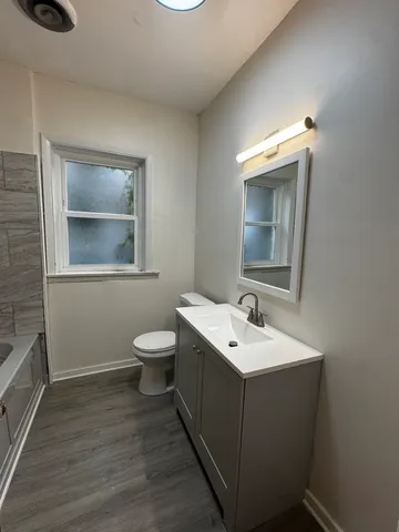 a bathroom with a toilet sink and mirror