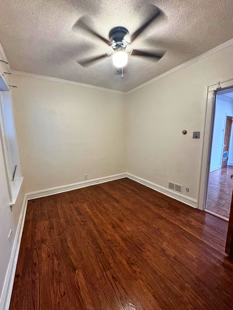 6937 South Merrill Avenue, Unit 1 Chicago, IL 60649 - Photo 8 of 17 a view of an empty room with wooden floor