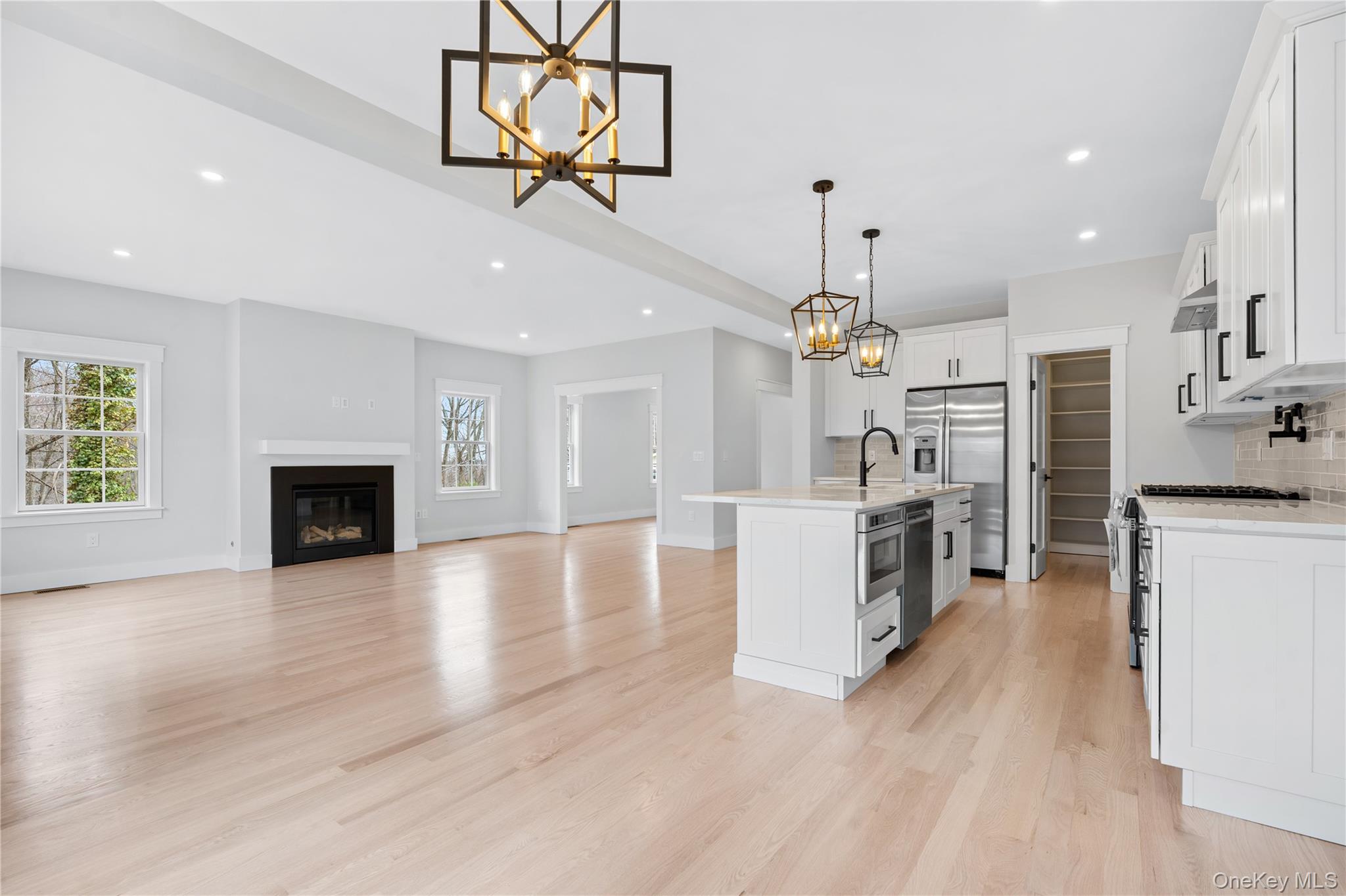 16 Stephens Lane Valhalla, NY 10595 - Photo 15 of 47 a view of a kitchen center island wooden floor and a fireplace