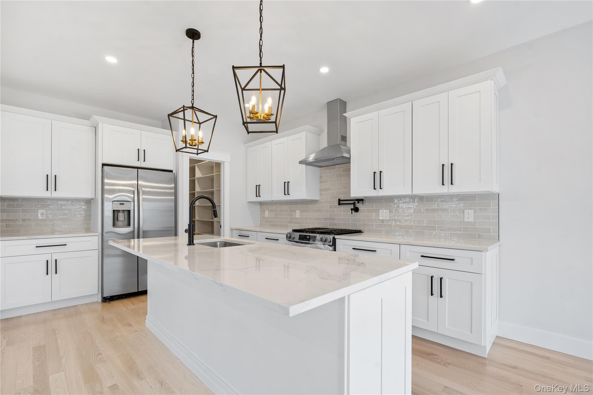 16 Stephens Lane Valhalla, NY 10595 - Photo 17 of 47 a kitchen with stainless steel appliances granite countertop a sink a stove and a wooden floors