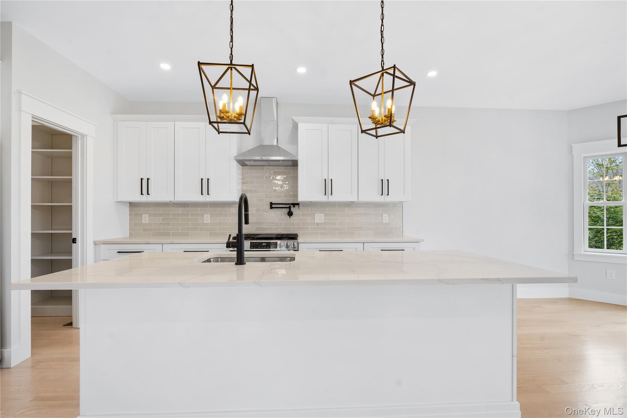 16 Stephens Lane Valhalla, NY 10595 - Photo 18 of 47 a view of a kitchen with center island and stainless steel appliances