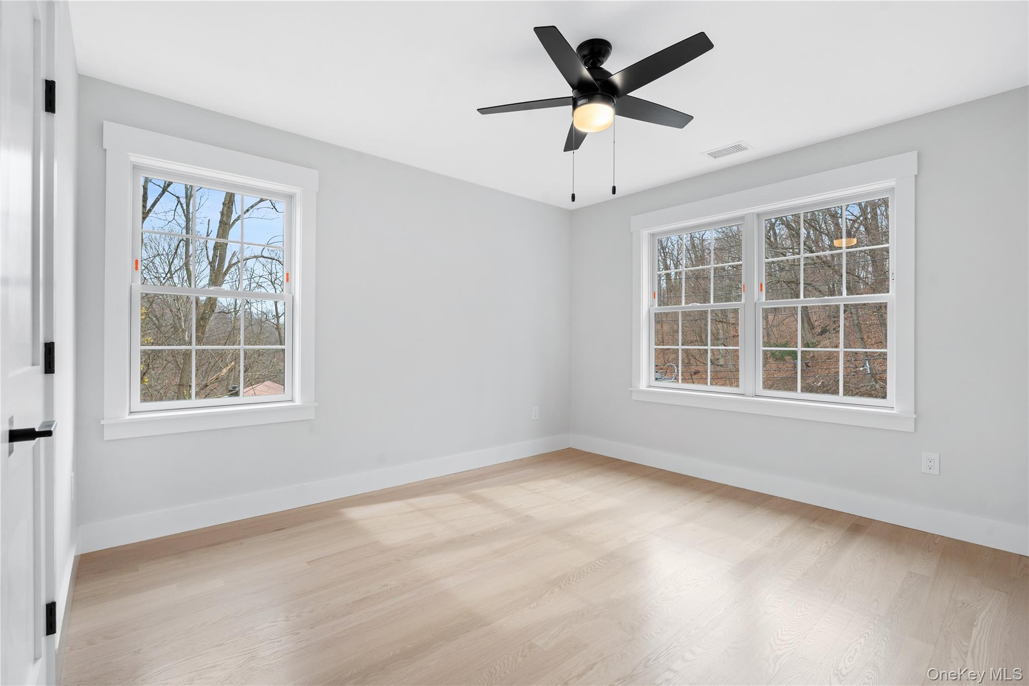 16 Stephens Lane Valhalla, NY 10595 - Photo 25 of 47 an empty room with wooden floor and windows