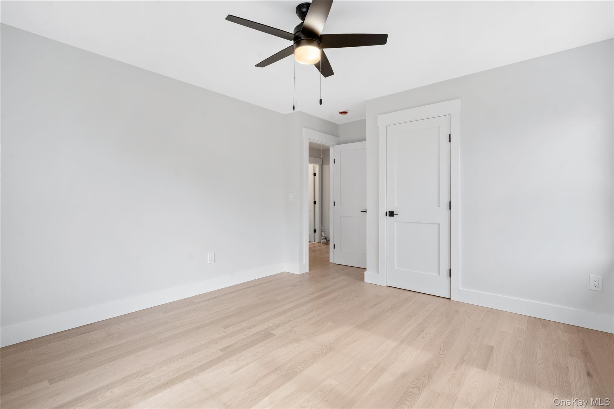 16 Stephens Lane Valhalla, NY 10595 - Photo 26 of 47 a view of a room with wooden floor and a ceiling fan