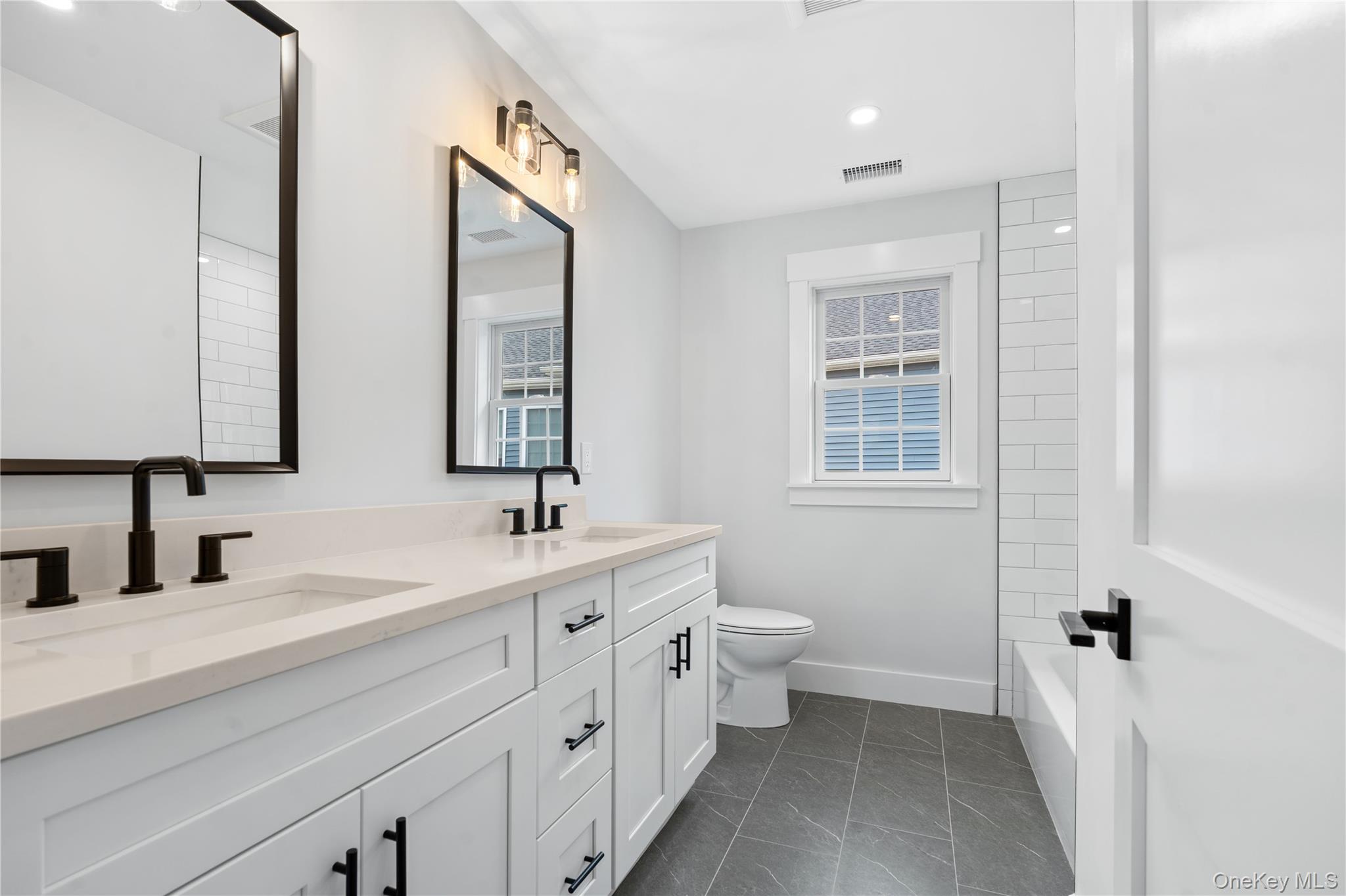16 Stephens Lane Valhalla, NY 10595 - Photo 29 of 47 a bathroom with a double vanity sink mirror and toilet