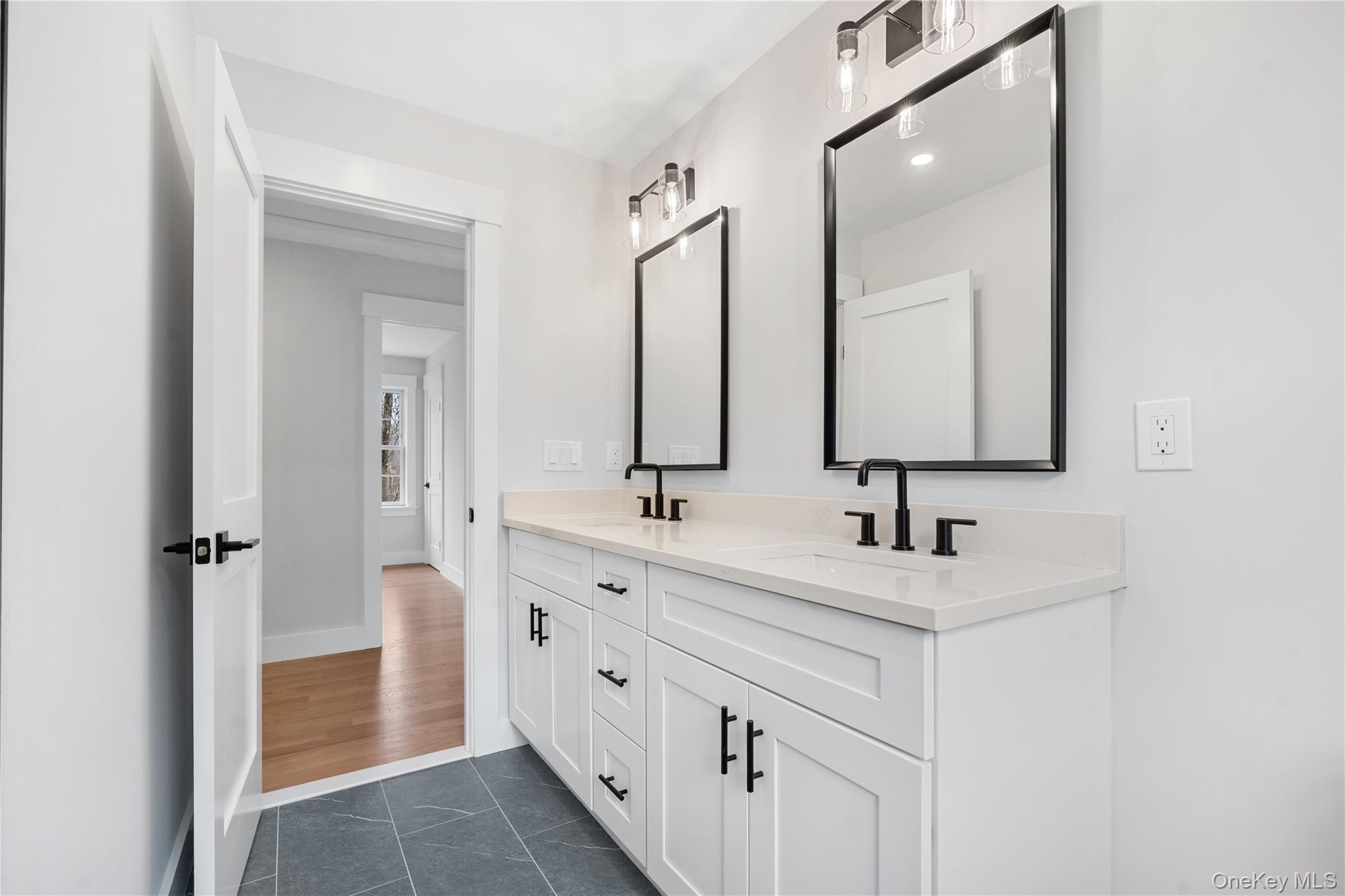 16 Stephens Lane Valhalla, NY 10595 - Photo 30 of 47 a bathroom with double vanity sink and a mirror