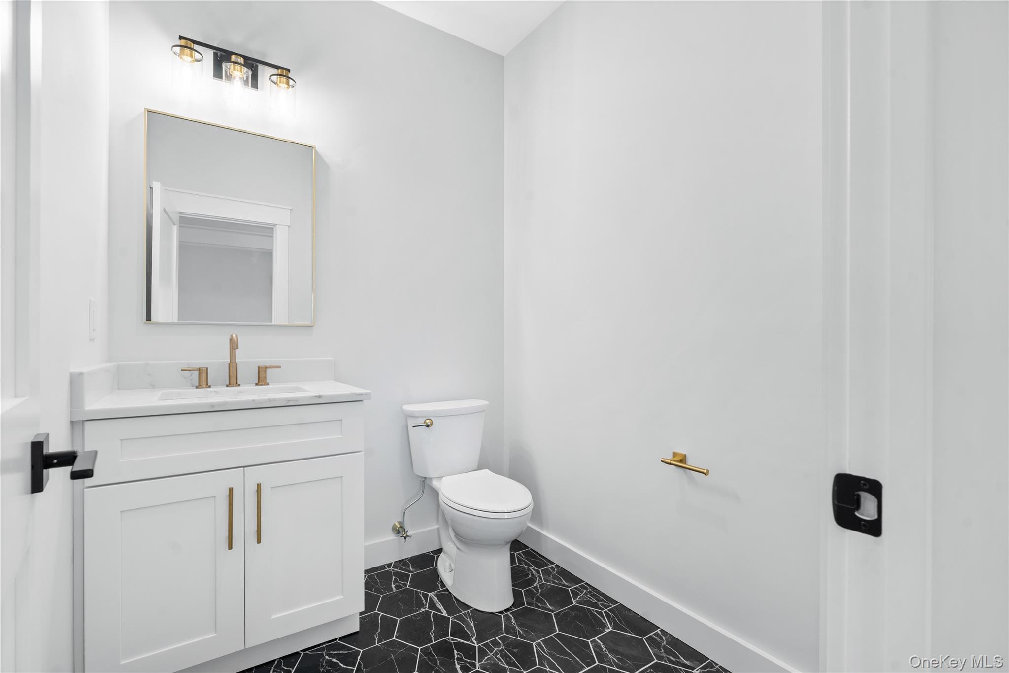 16 Stephens Lane Valhalla, NY 10595 - Photo 9 of 47 a bathroom with a sink a toilet and a mirror