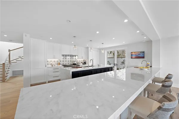a front view of a house with a yard and potted plants