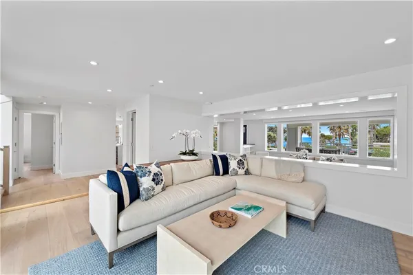 a living room with furniture tv and a large window