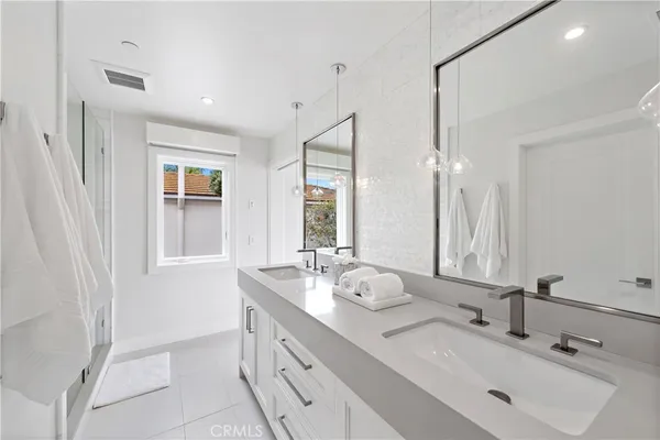 an aerial view of residential houses with outdoor space and parking